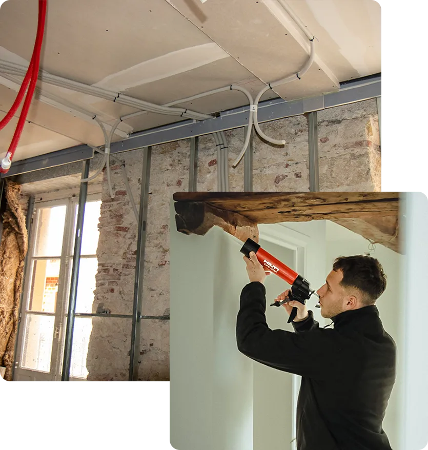 Artisan d'ADS Rénovation en train de poser un isolant thermique sur ossature métallique mur intérieur